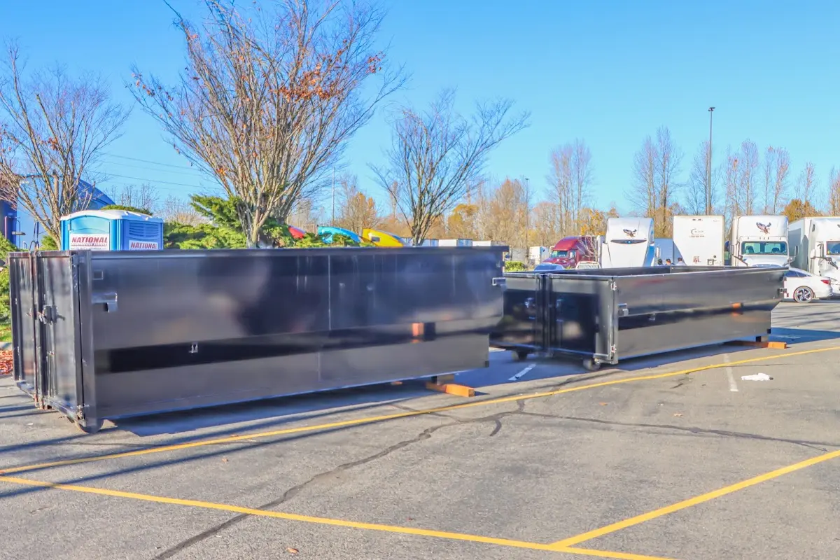 Professional dumpster rental service with roll-off container on residential driveway in San Fernando